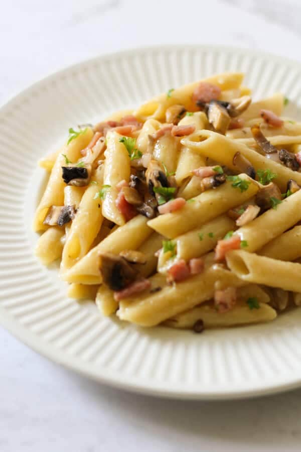 Creamy Carbonara on a white plate.