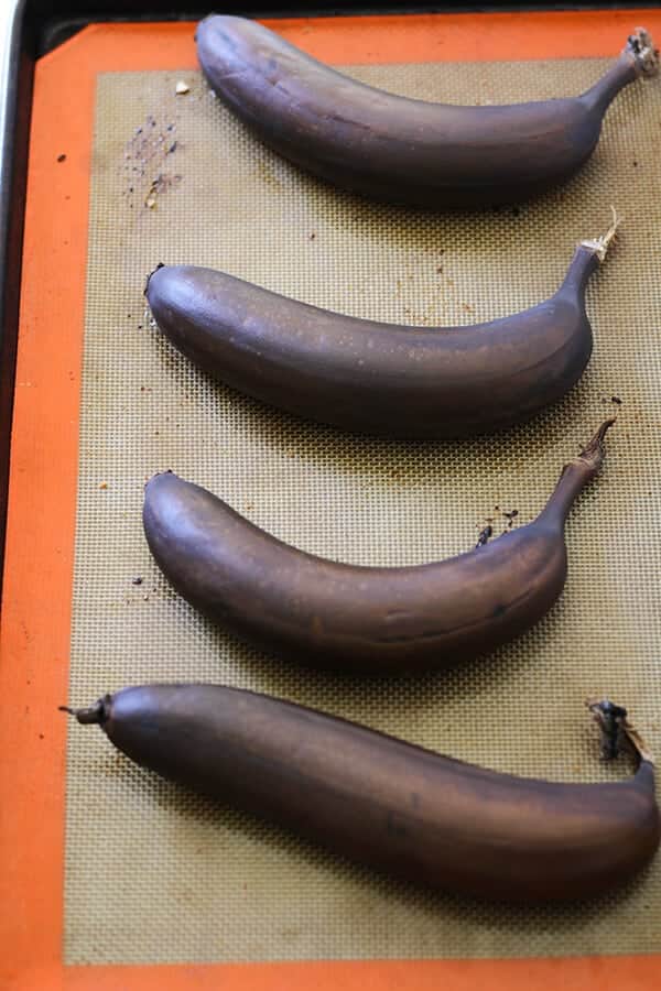 Roasted bananas on a baking tray.