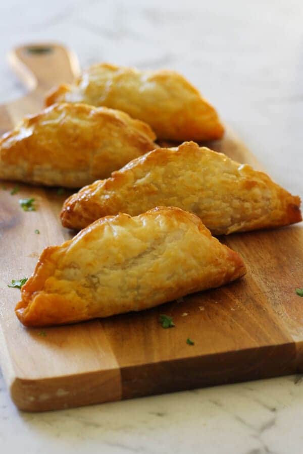 Beef Pasties on a wooden board.