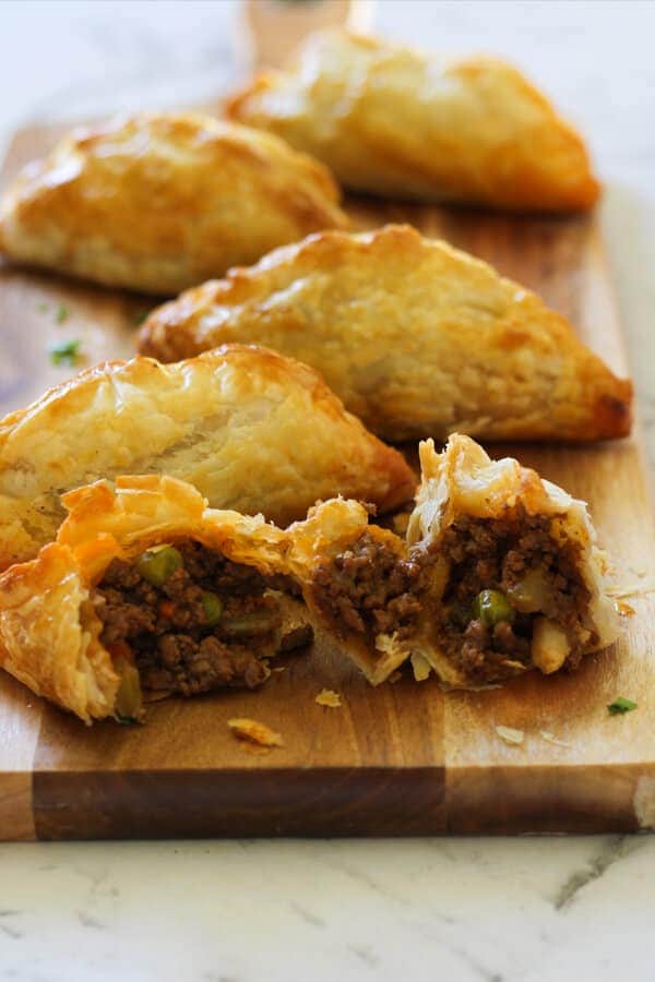 Beef Pasties on a wooden board.