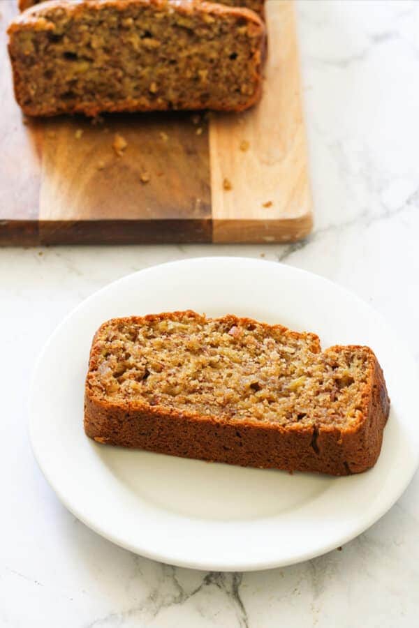 a slice of banana bread on a white plate.