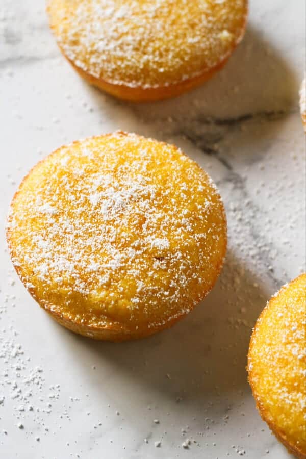 Orange and almond cakes on a marble board.