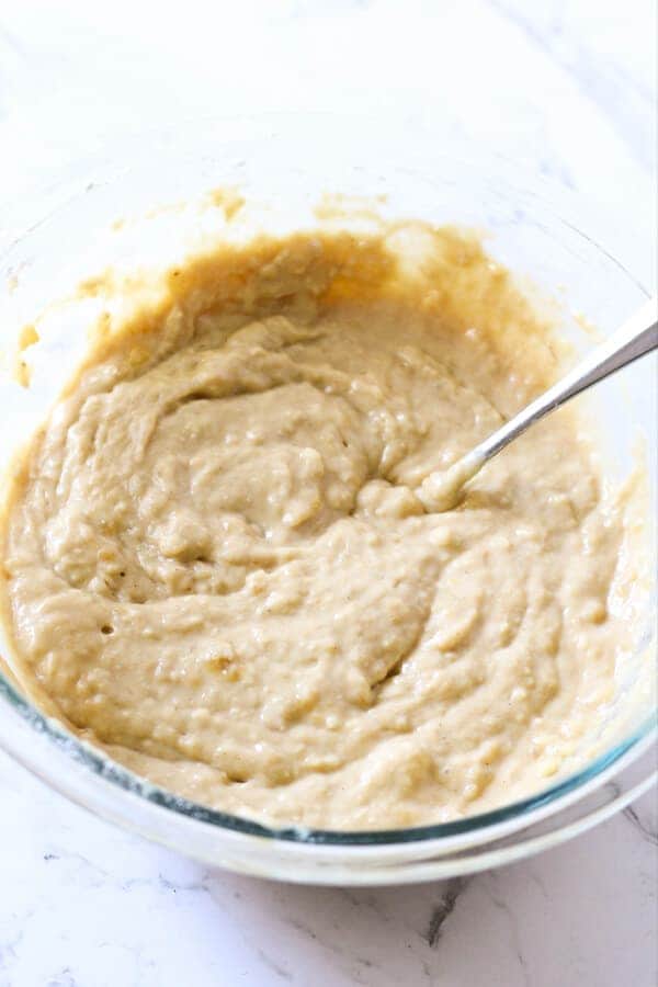 banana bread ingredients mixed in a glass bowl. 