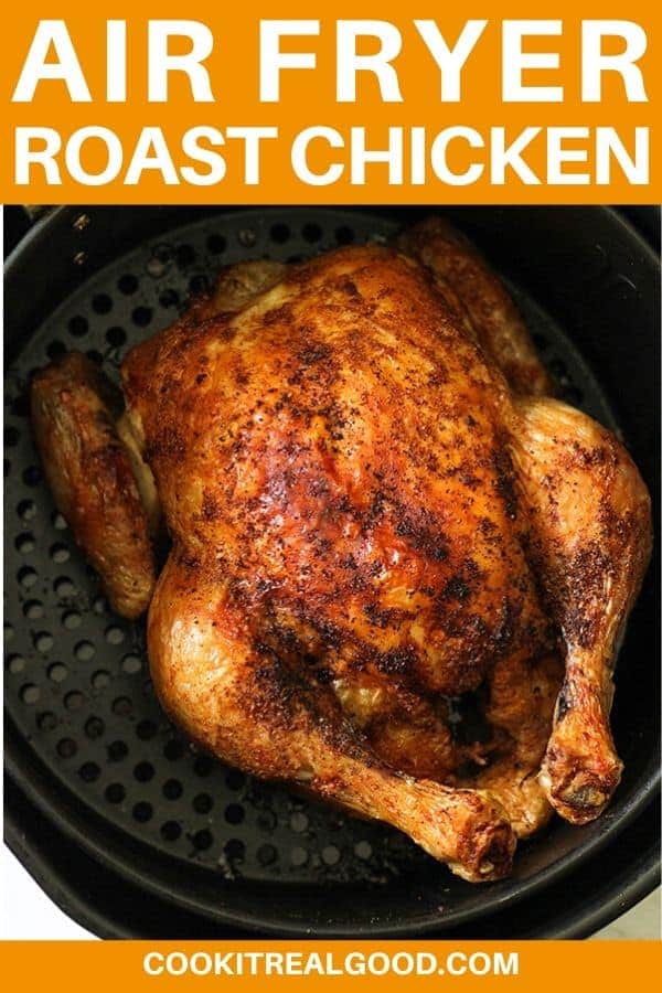 Whole roast chicken sitting in air fryer basket with text overlay "air fryer whole chicken".
