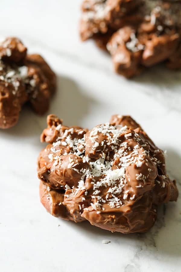 chocolate covered almonds on a marble background.