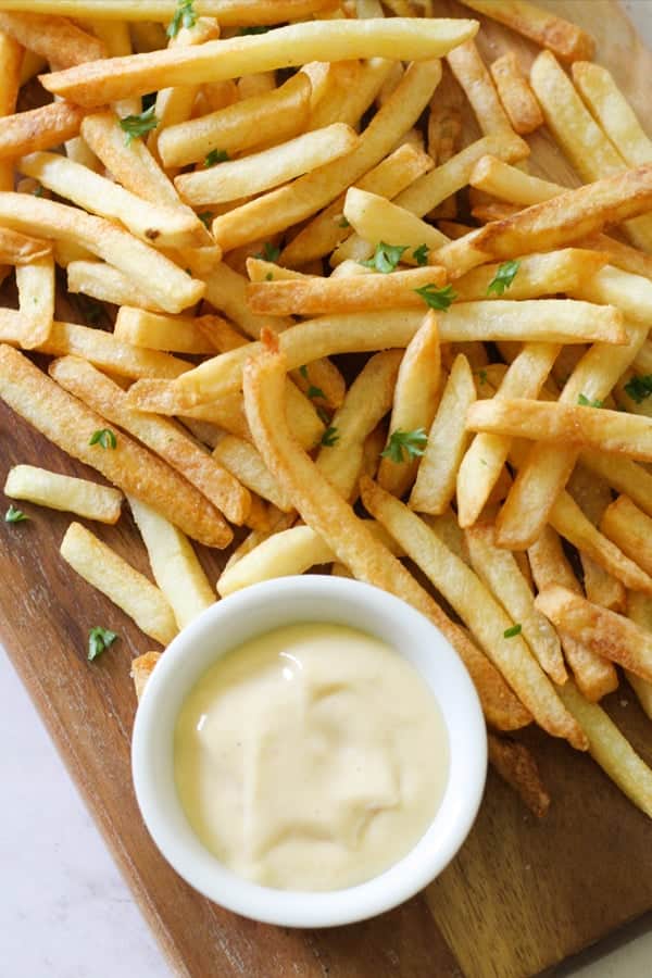 fries on a wooden board.
