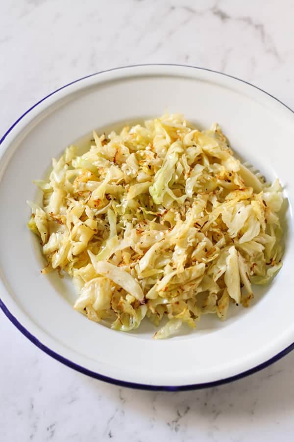 sauteed cabbage in a white bowl.