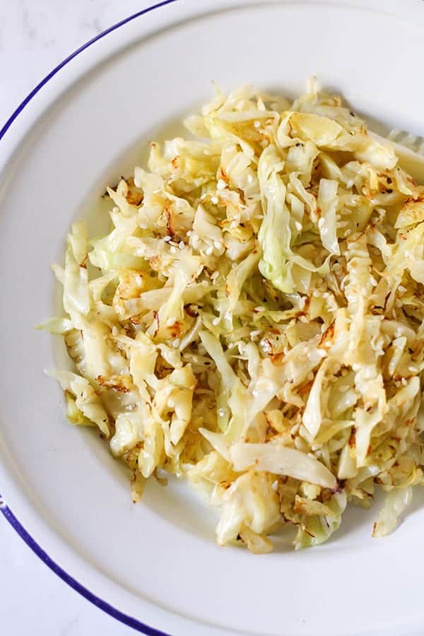 sauteed cabbage in a white bowl.