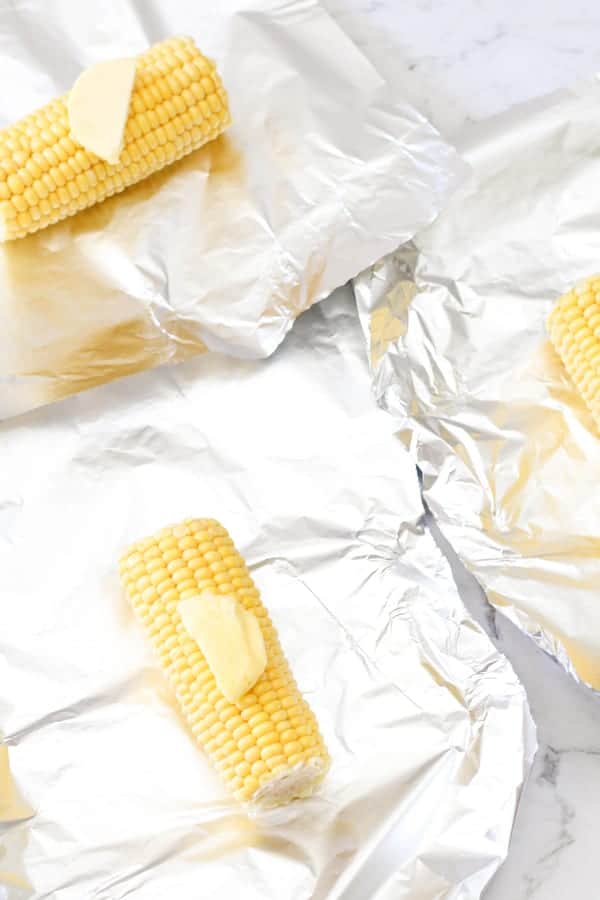 corn ears on aluminium foil.