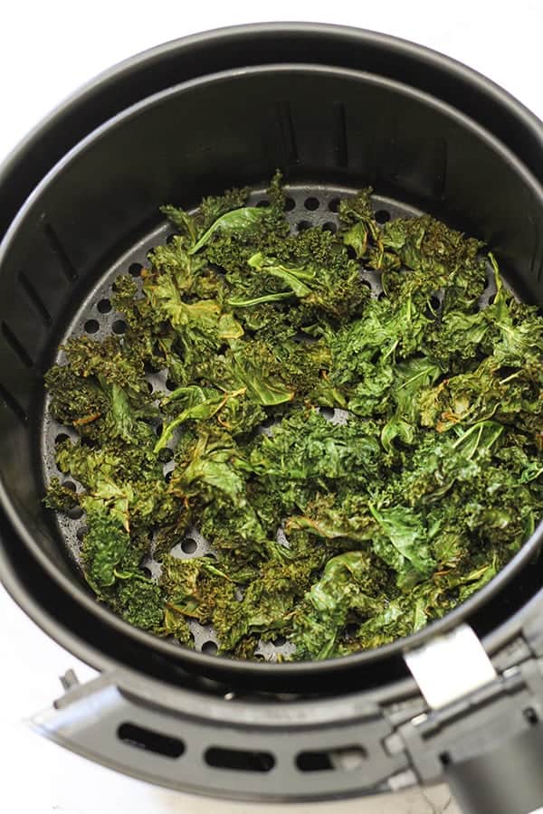 sweet & salty kales chips in an air fryer basket.