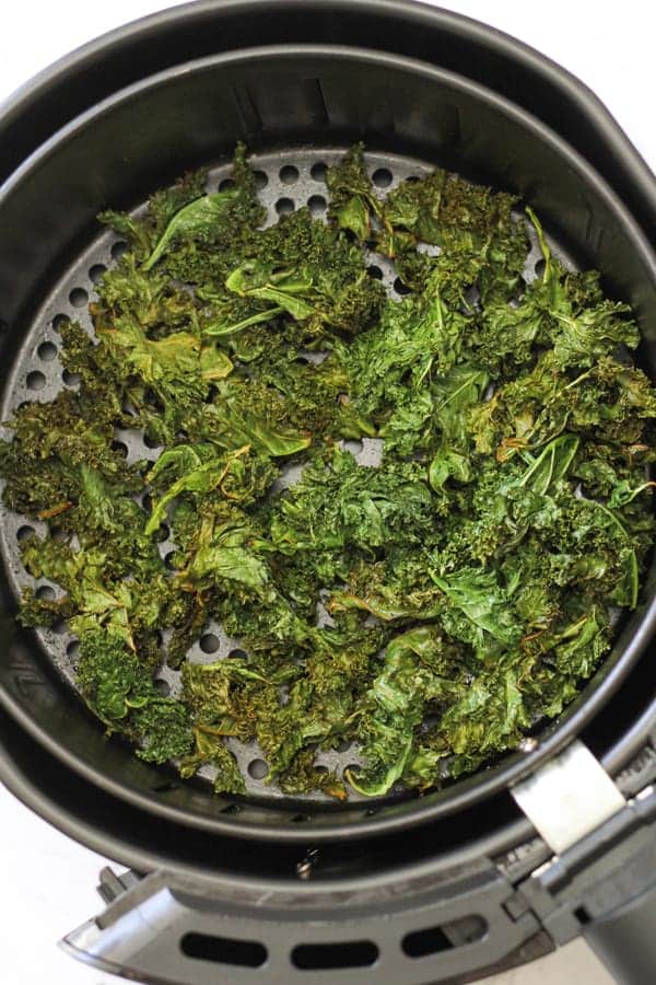 sweet & salty kales chips in an air fryer basket.