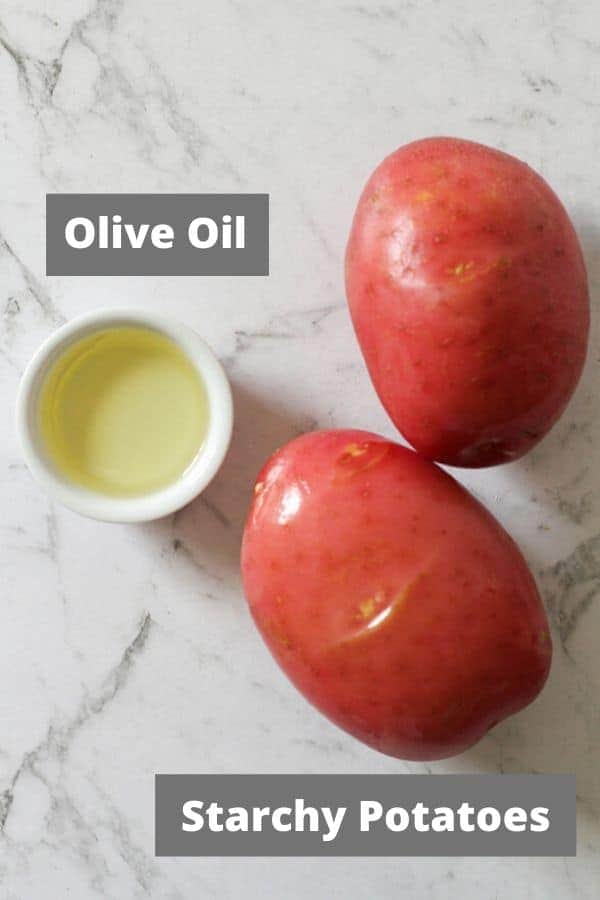 ingredients for baked potatoes on a white marble background.