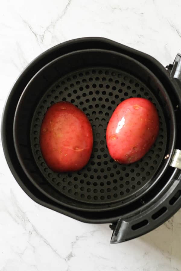 potatoes in an air fryer basket.