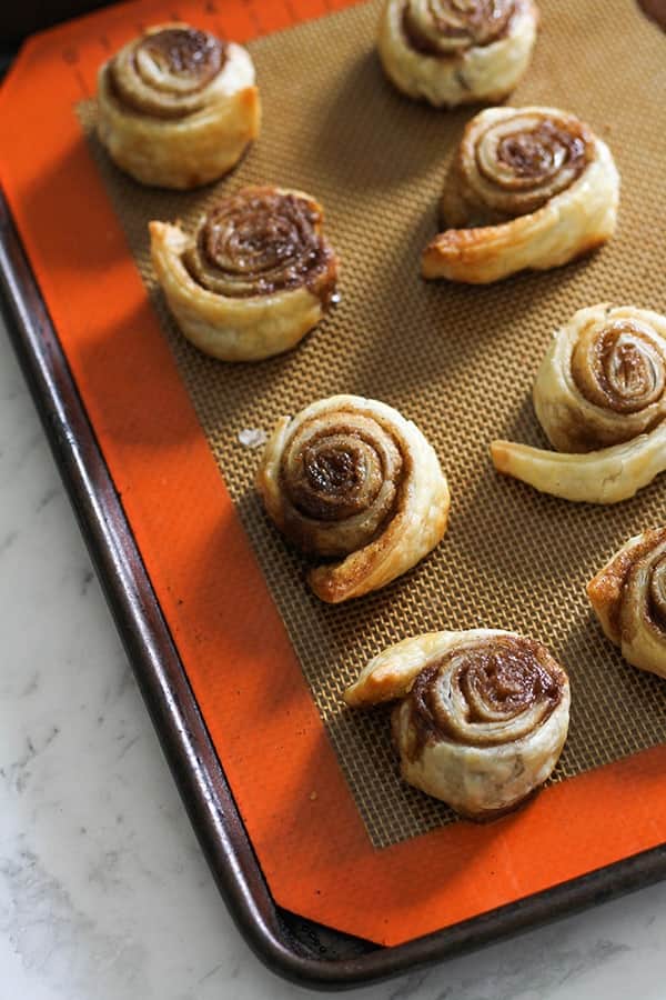 cinnamon pinwheels on a baking tray.
