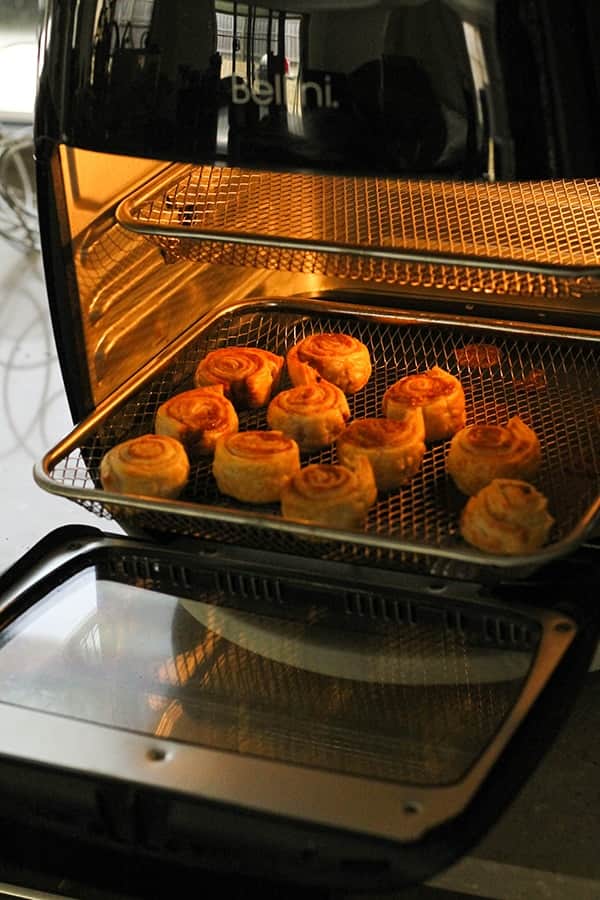 cinnamon pinwheels being cooked in the air fryer.