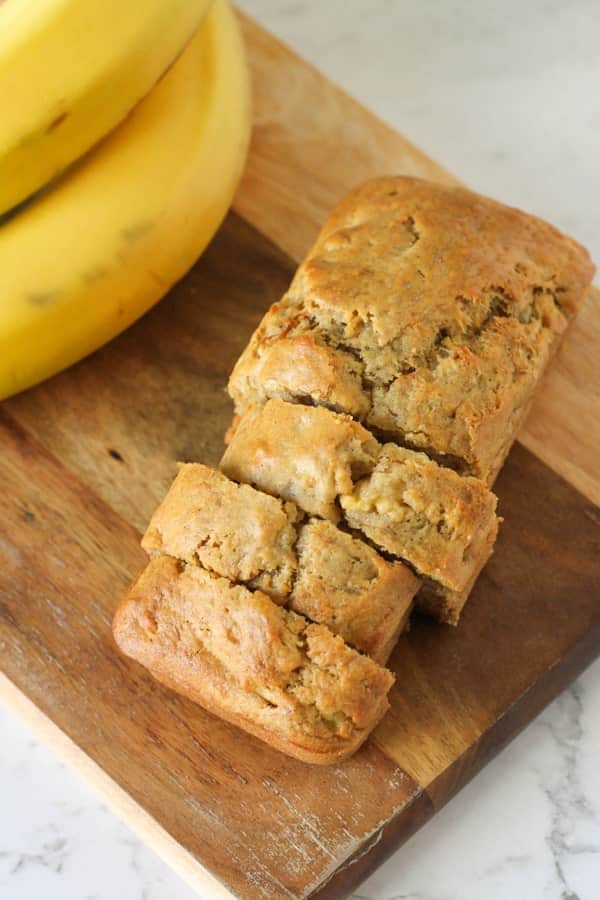 Mini banana loaf on a wooden cutting board.