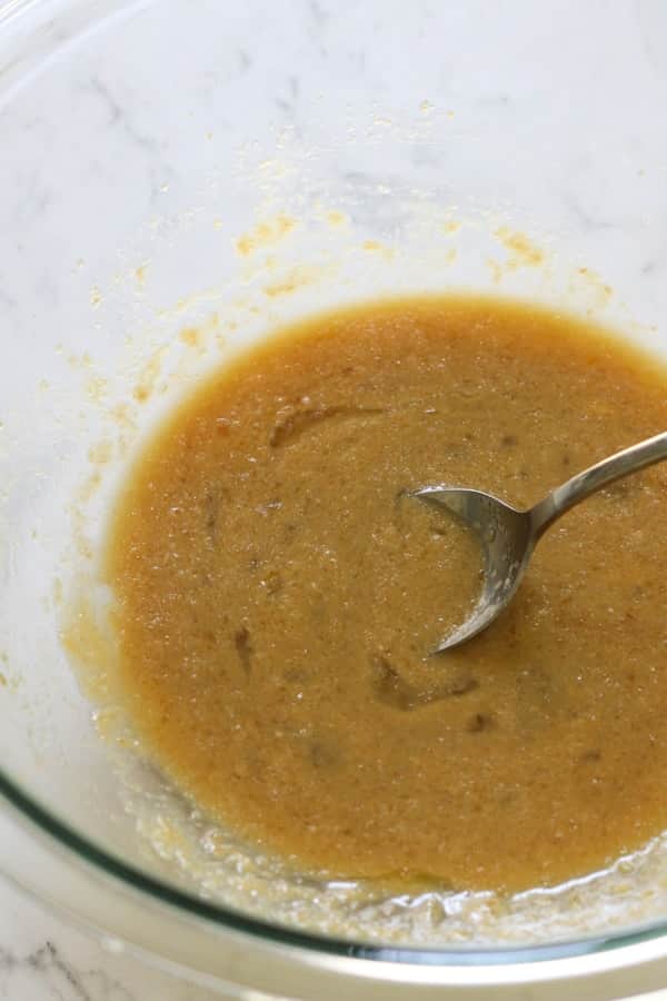 butter and sugar mixed together in a glass mixing bowl.