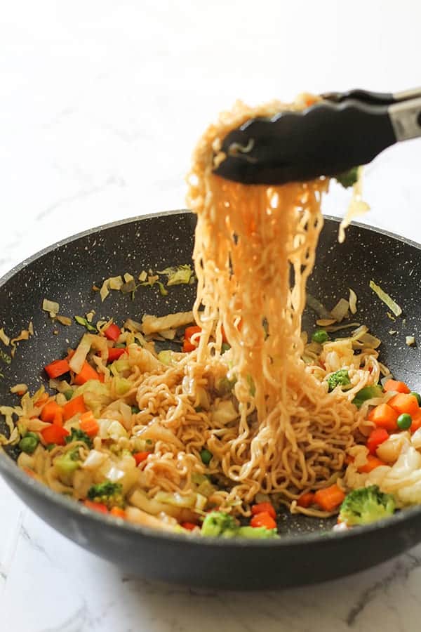 vegetable stir fry with noodles in a wok.