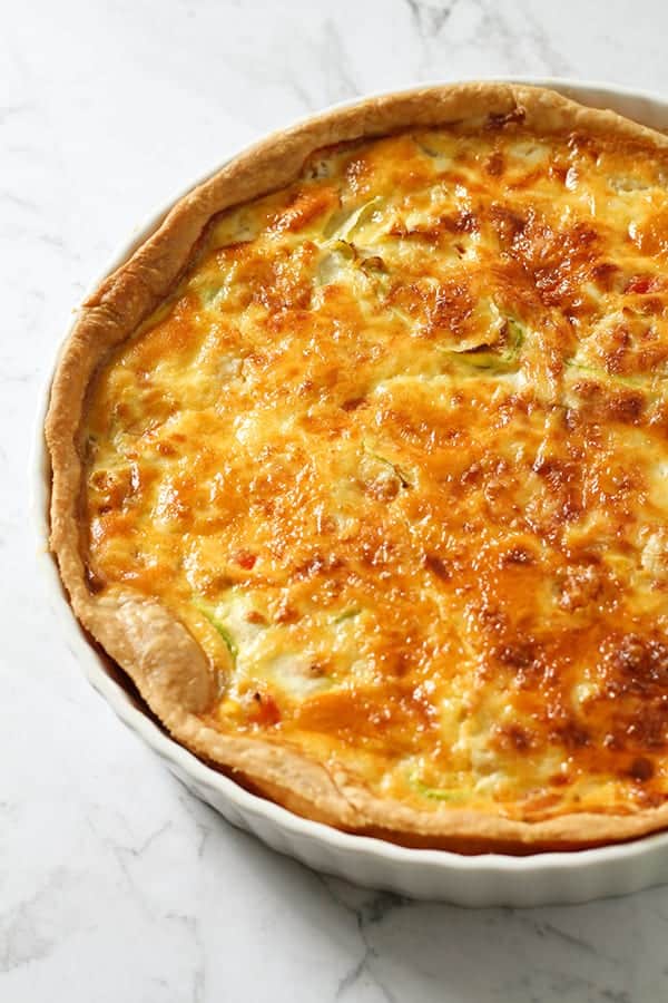 vegetarian quiche in a white quiche dish.