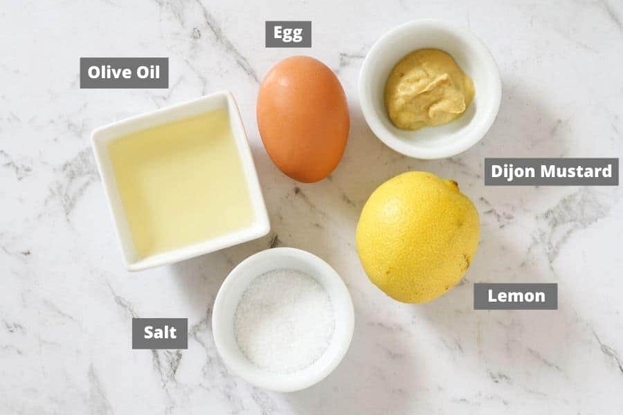 ingredients for whole30 mayo laid out on a white marble background.