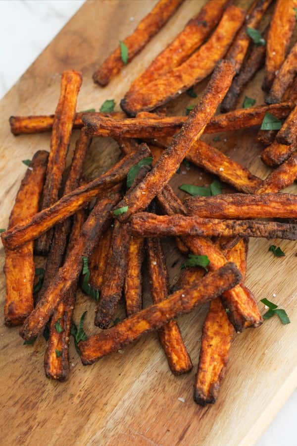 carrot fries on a wooden serving board.