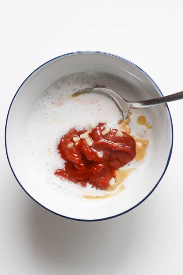 ingredients for peanut hoisin sauce in a white bowl.