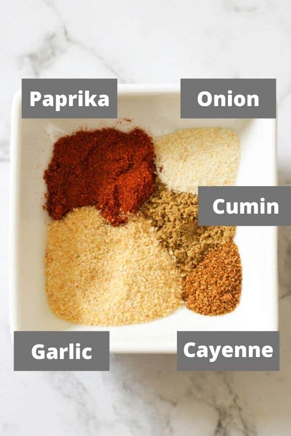 spices for vegetarian three bean chili in a white bowl.