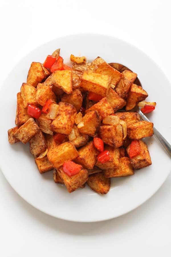 breakfast potatoes on a white plate.