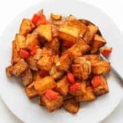 breakfast potatoes on a white plate.