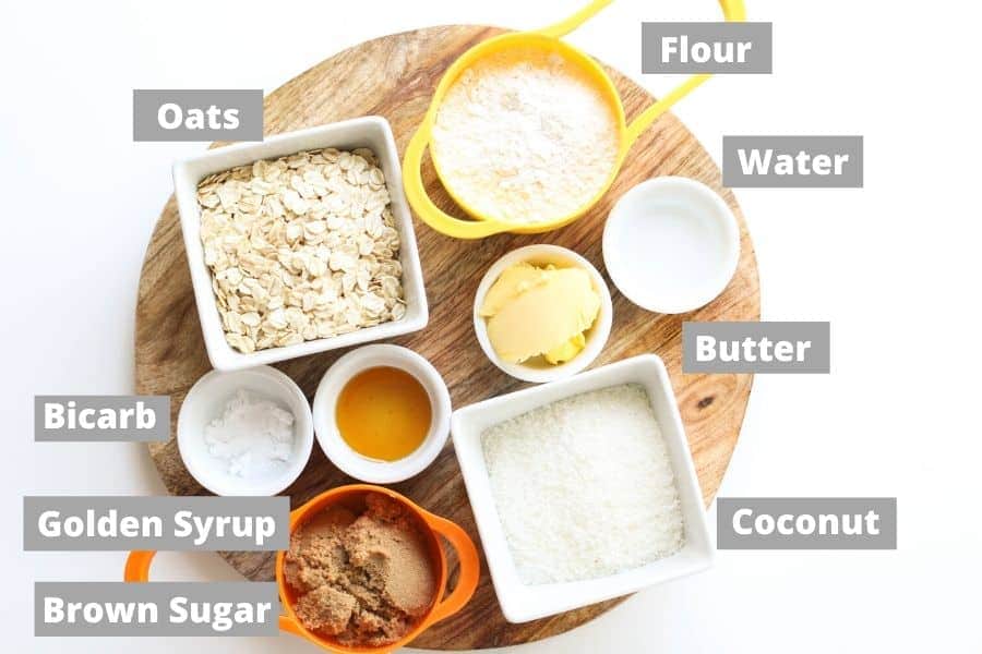 ingredients for anzac slice on a wooden board.