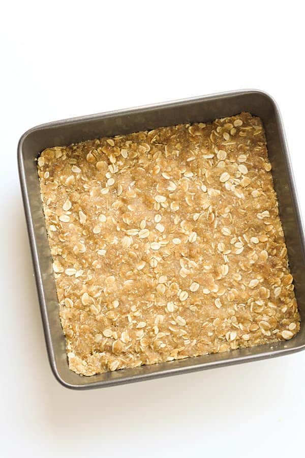 unbaked anzac slice in a slice pan. 