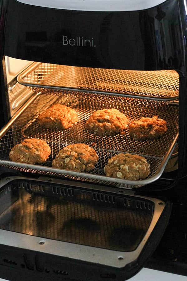 biscuits baking in an air fryer.