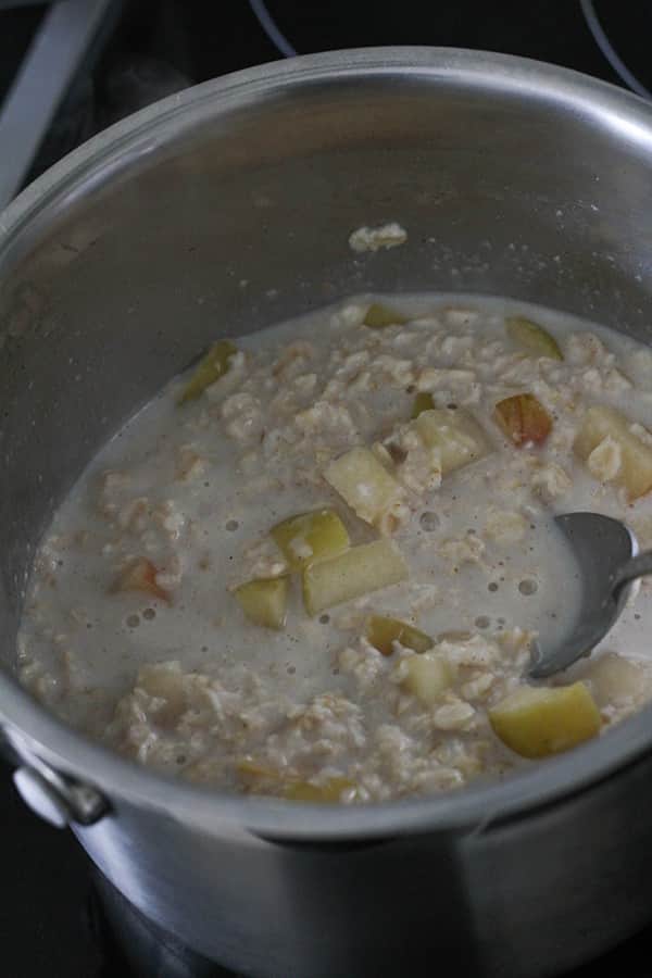 apple pieces, oatmeal and milk in a saucepan. 