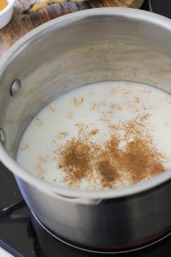 saucepan filled with oats, cinnamon and milk.