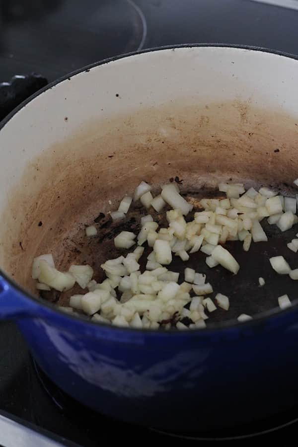 onion cooking in a dutch oven.