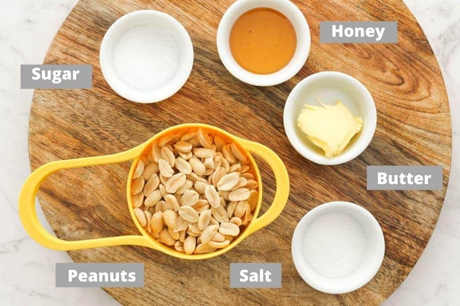 ingredients for honey roasted peanuts on a wooden board.