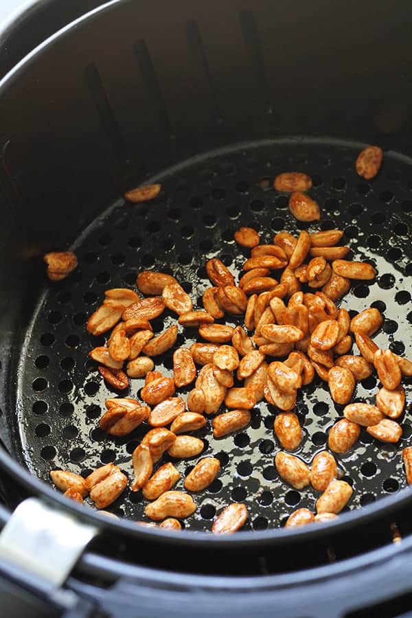 roasted peanuts in an air fryer basket.