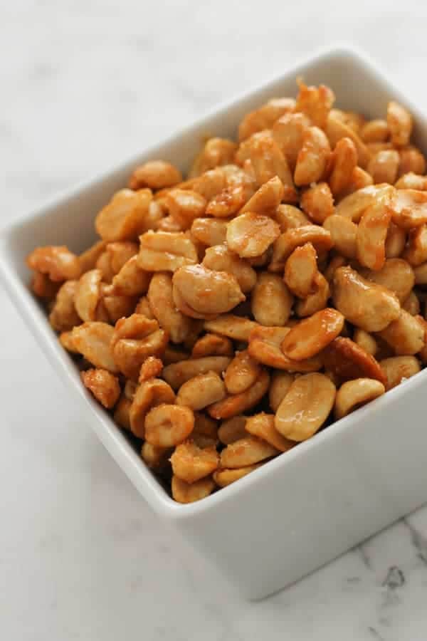 roasted peanuts in white square bowl. 