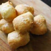 pretzel bites stacked on a wooden serving board.