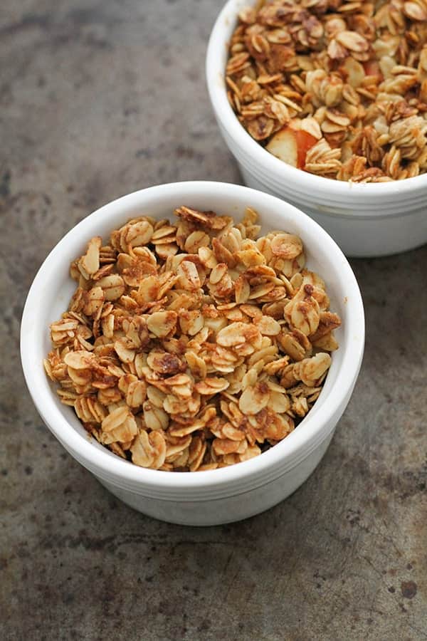 two apple crisps side by side in white ramekins.