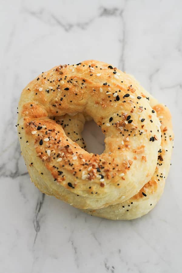 bagels stacked on top of each other on a marble board.