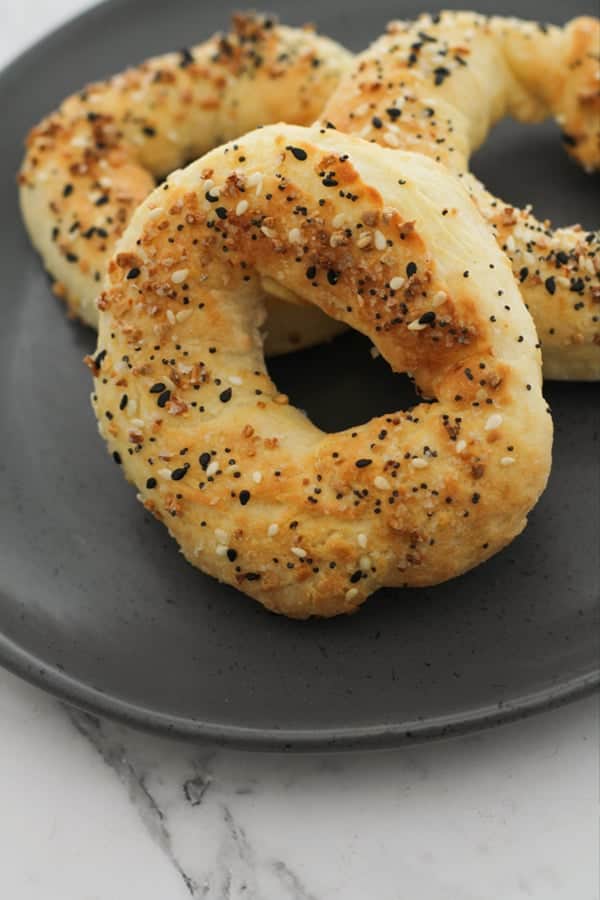 bagels laid on a grey plate.