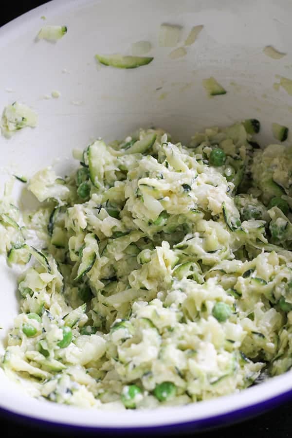 fritter ingredients mixed together in a white mixing bowl.