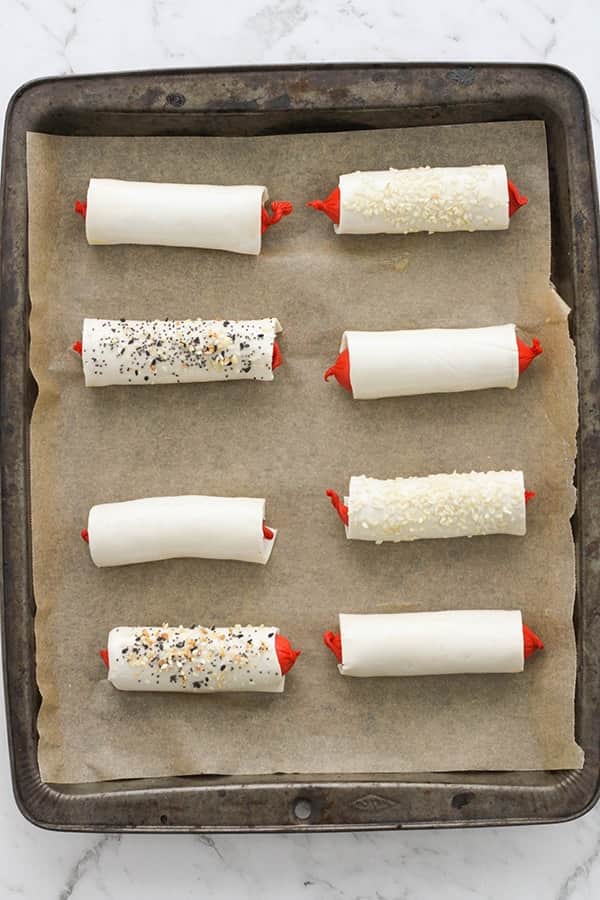 puffy dogs on a baking tray ready to be cooked.