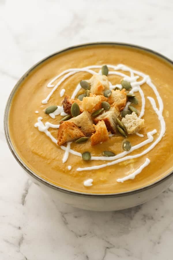pumpkin soup topped with croutons and pumpkin seeds.
