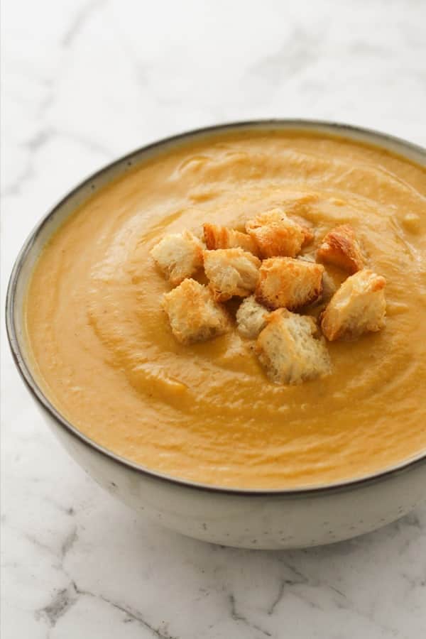 pumpkin and cauliflower soup topped with croutons.
