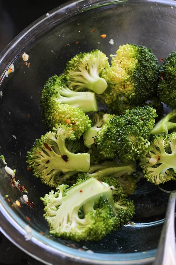 broccoli florets in a glass bowl.