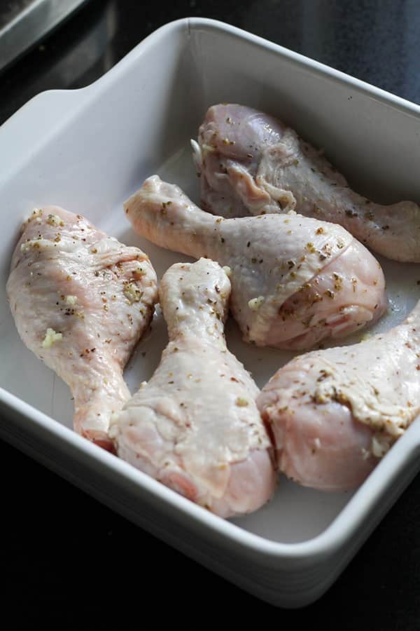 chicken drumsticks in a baking dish.