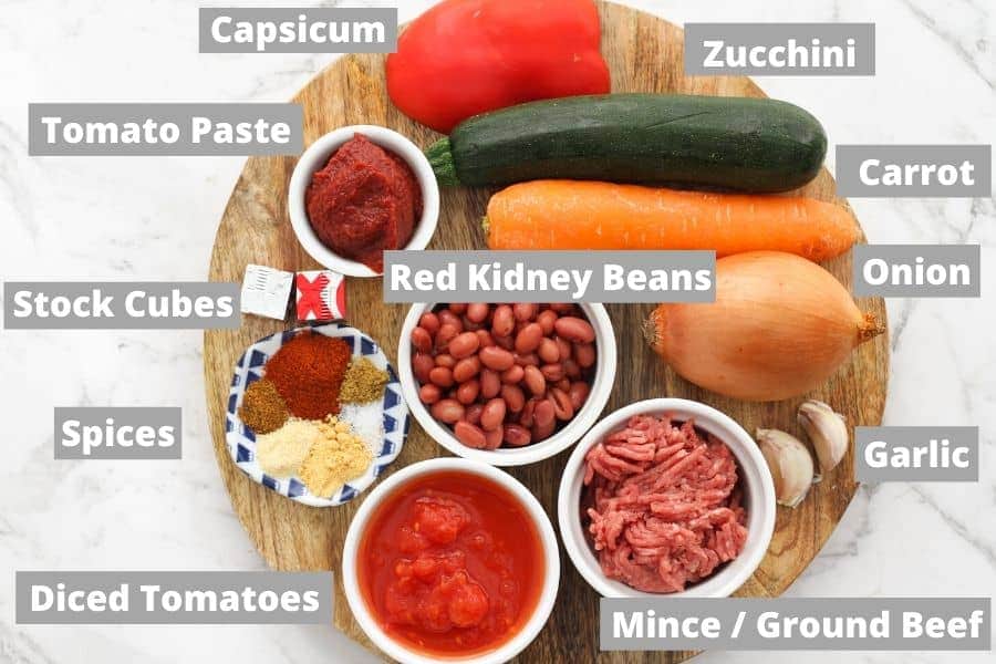 ingredients for chilli on a wooden board.