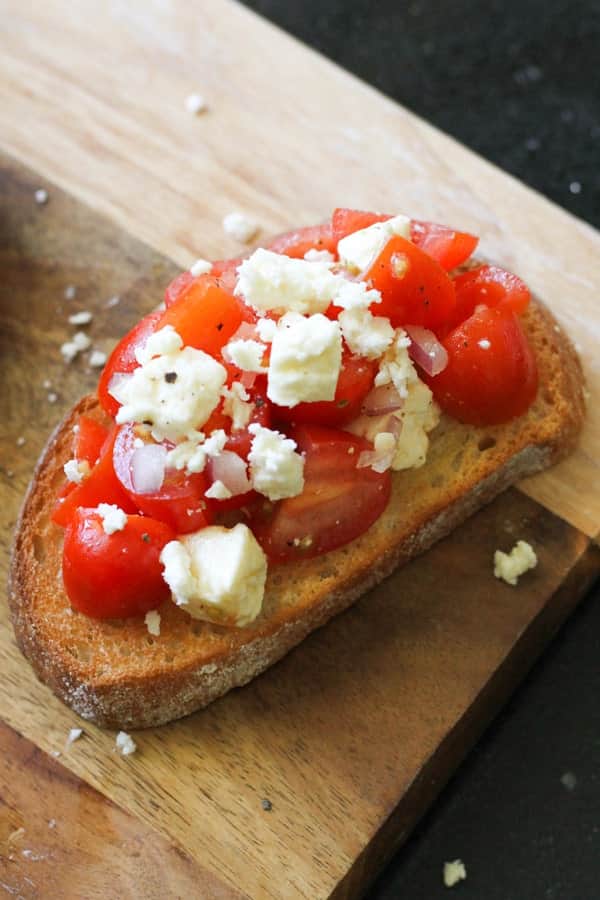 bruschetta on a wooden serving board.